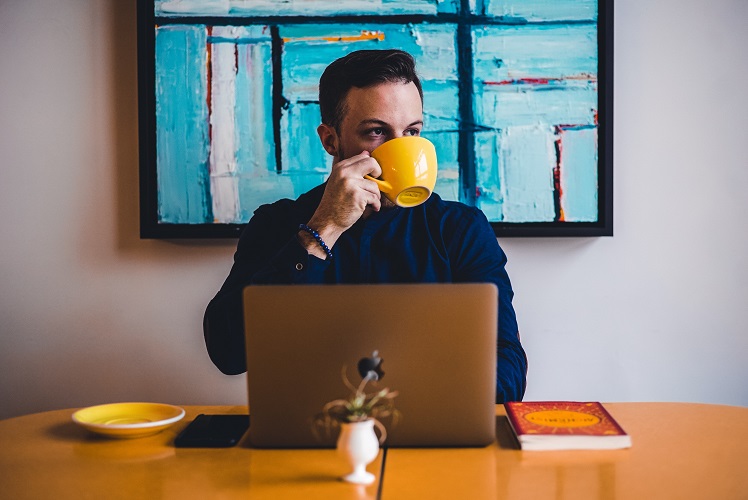 man drinking coffee - how to reduce cortisol - diagnost