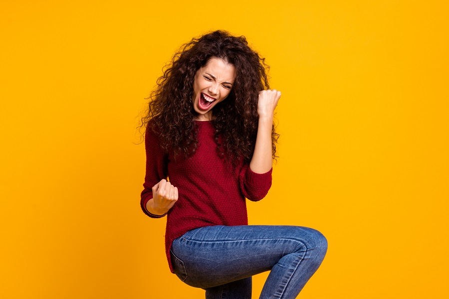 happy woman celebrating - things to do to boost your progesterone - Diagnost